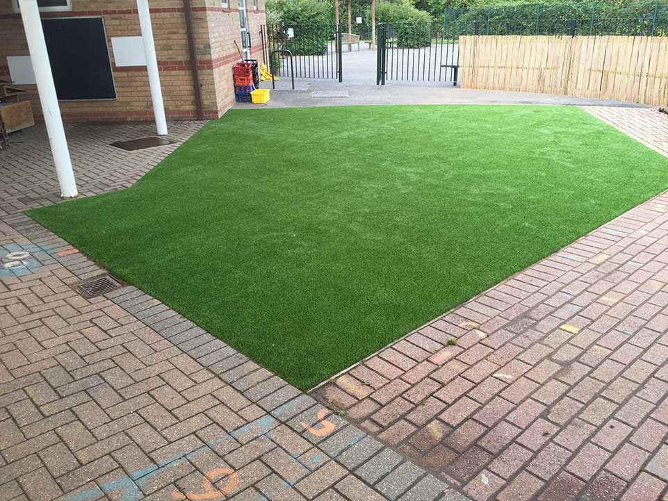Family home with artificial grass and block paving